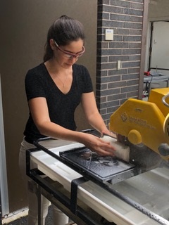 Logan Brenner cutting coral on a table saw