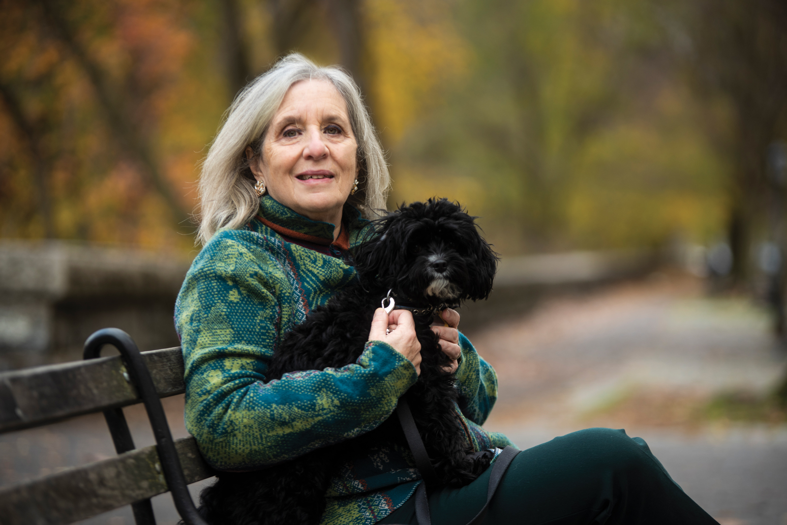 Mary Gordon photo on a park bench with her dog