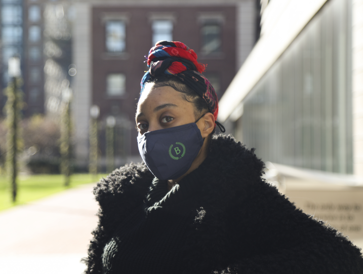 Student Naomi Jones standing on campus with the Milstein library in the background.