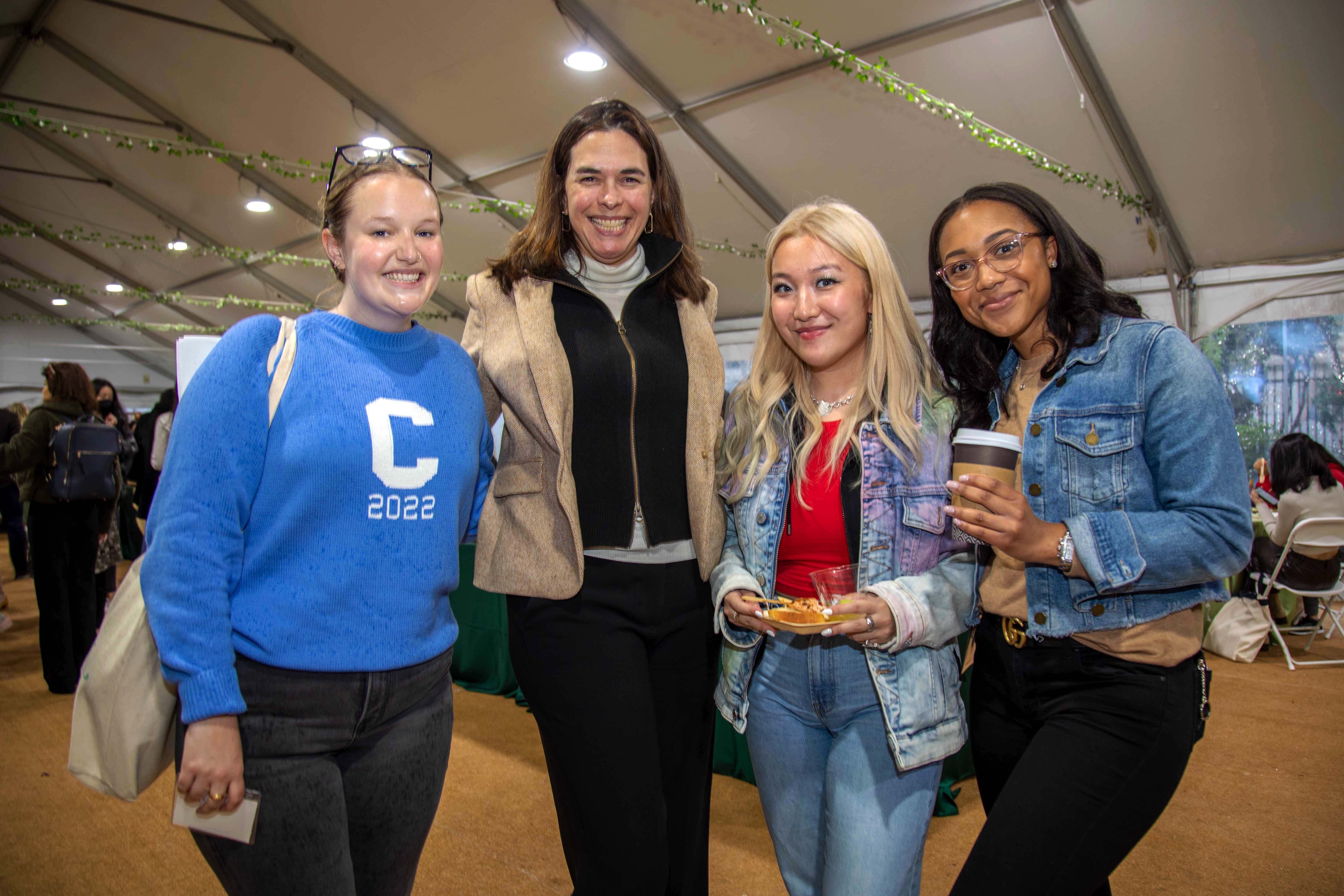 President Beilock with three seniors under the Futter Field tent.