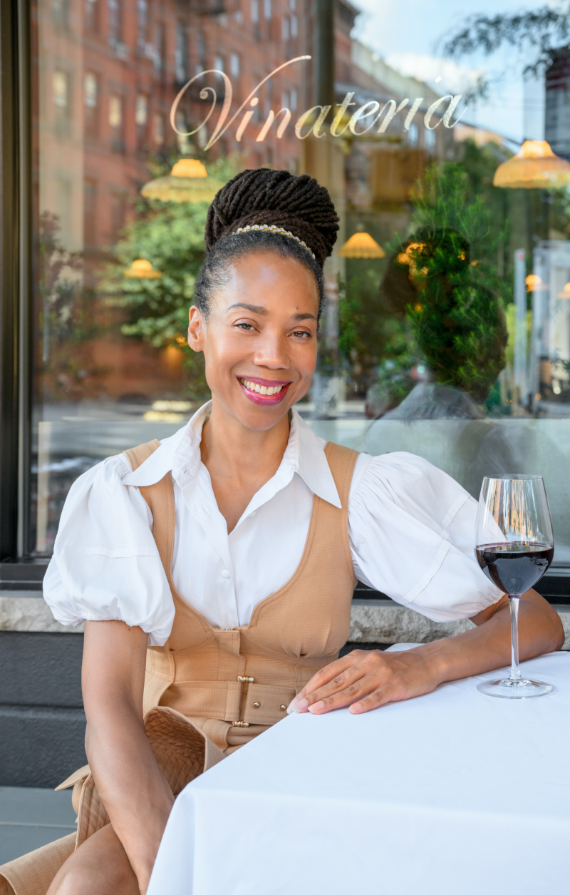 Yvette Leeper sitting with glass of wine