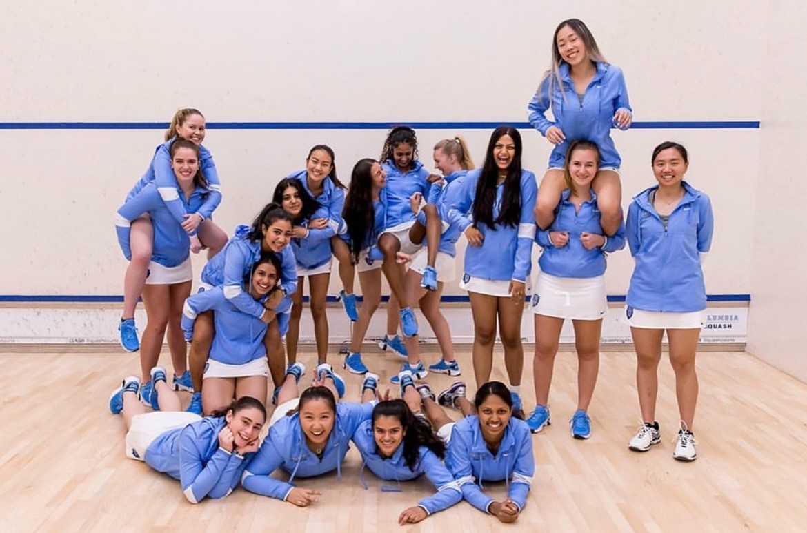 Mishra with team members on the court