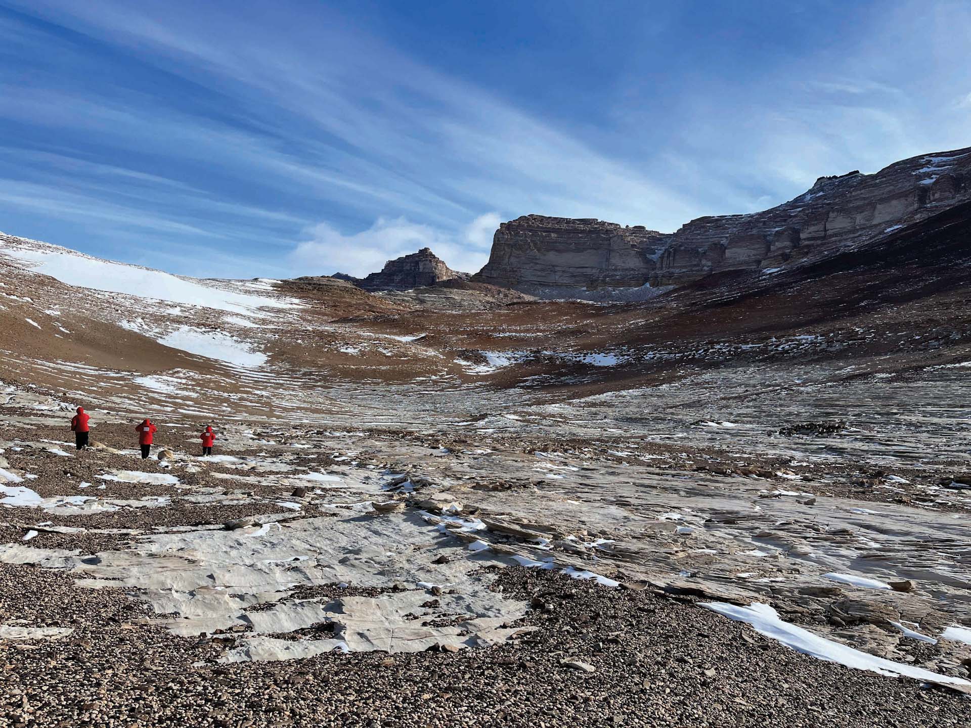 3 scientists in rocky field Antarctica