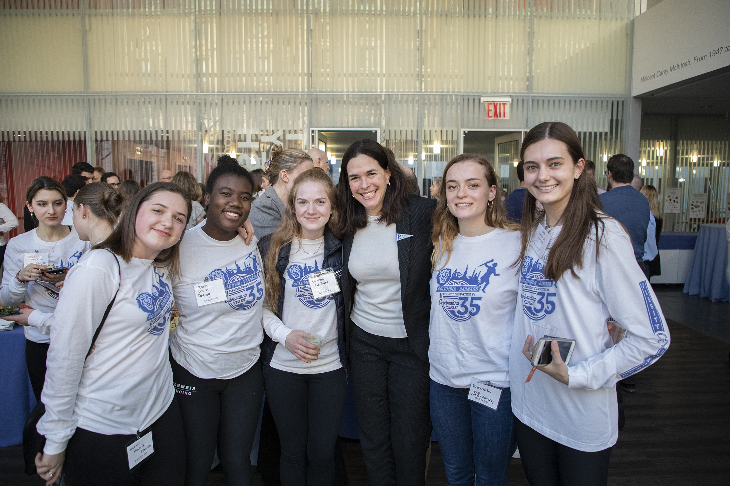 Sian Beilock posing with a group of five barnard student athletes