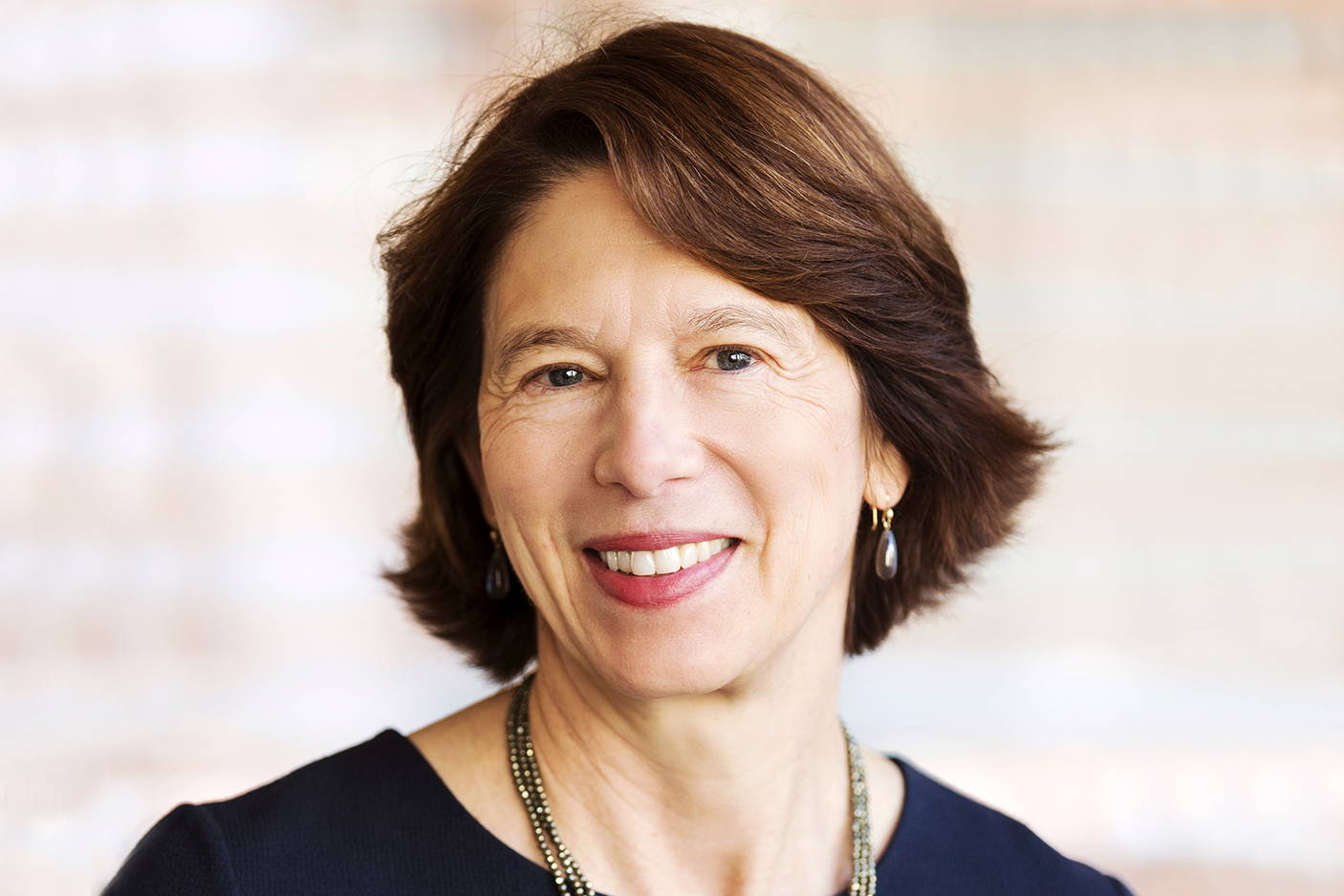 Smiling white woman with short brown hair black top