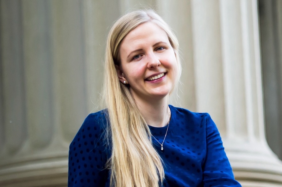 Photo of Prof. Alisa Knizel wearing a blue hair and showing her long blond hair.