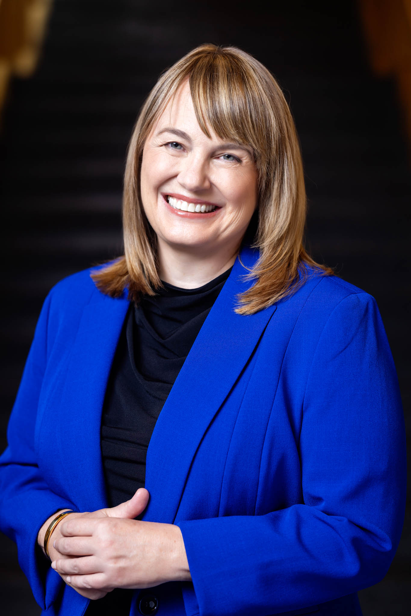 Laura Rosenbury wearing a bright blue blazer, smiling