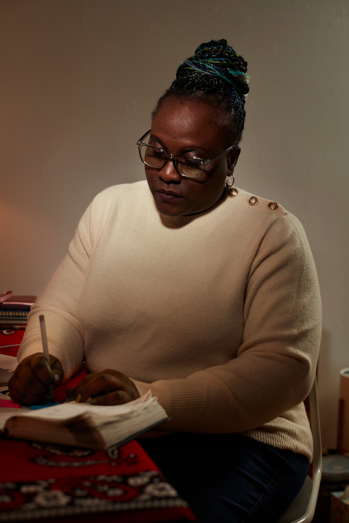 Playwright Achiro P. Olwoch at the desk writing