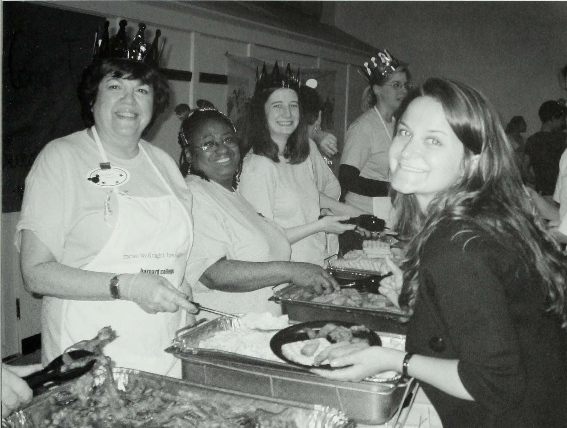 student being served by President Shapiro at midnight breakfast