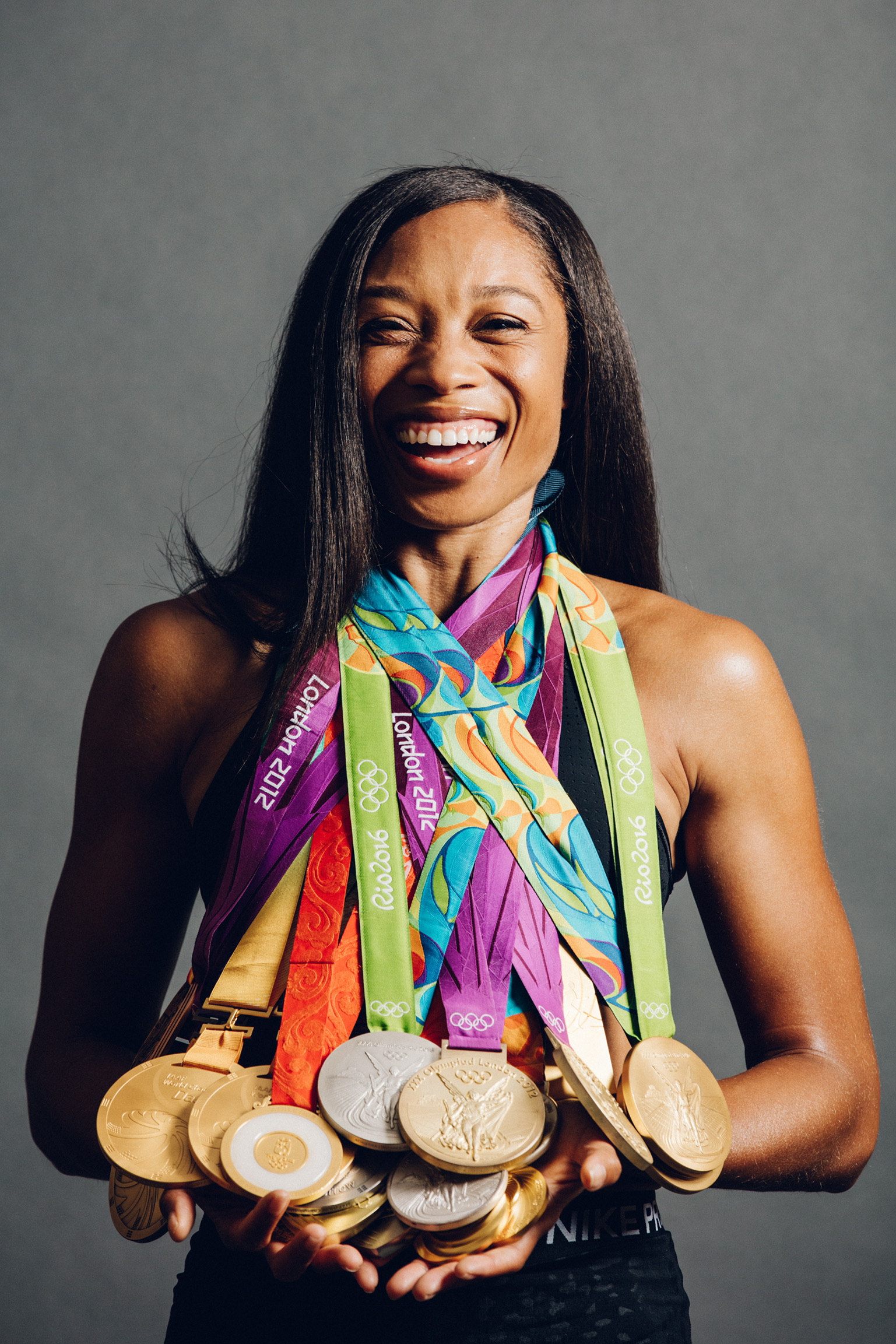 Allyson Felix wearing multiple medals