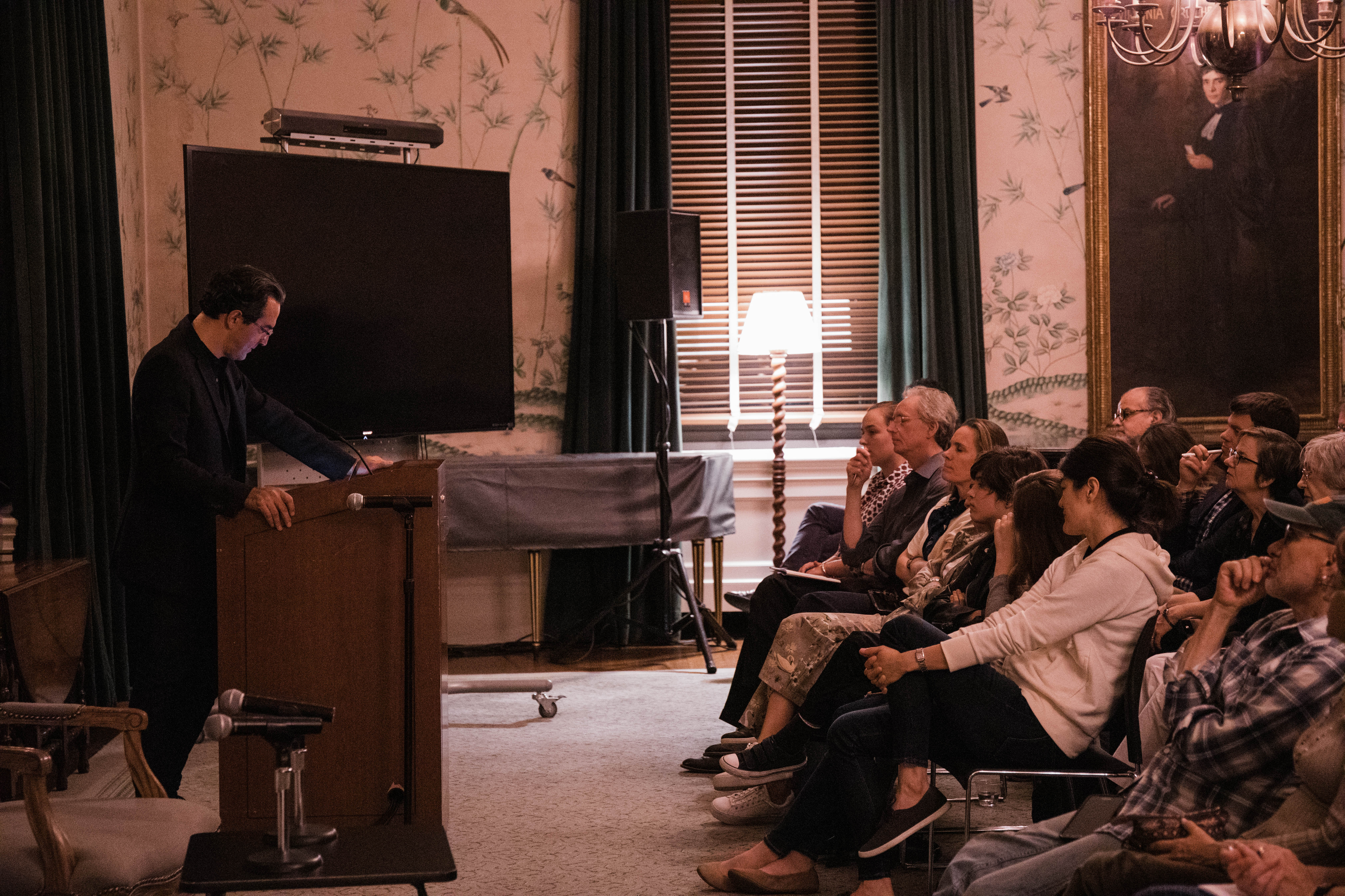 At lectern and audience