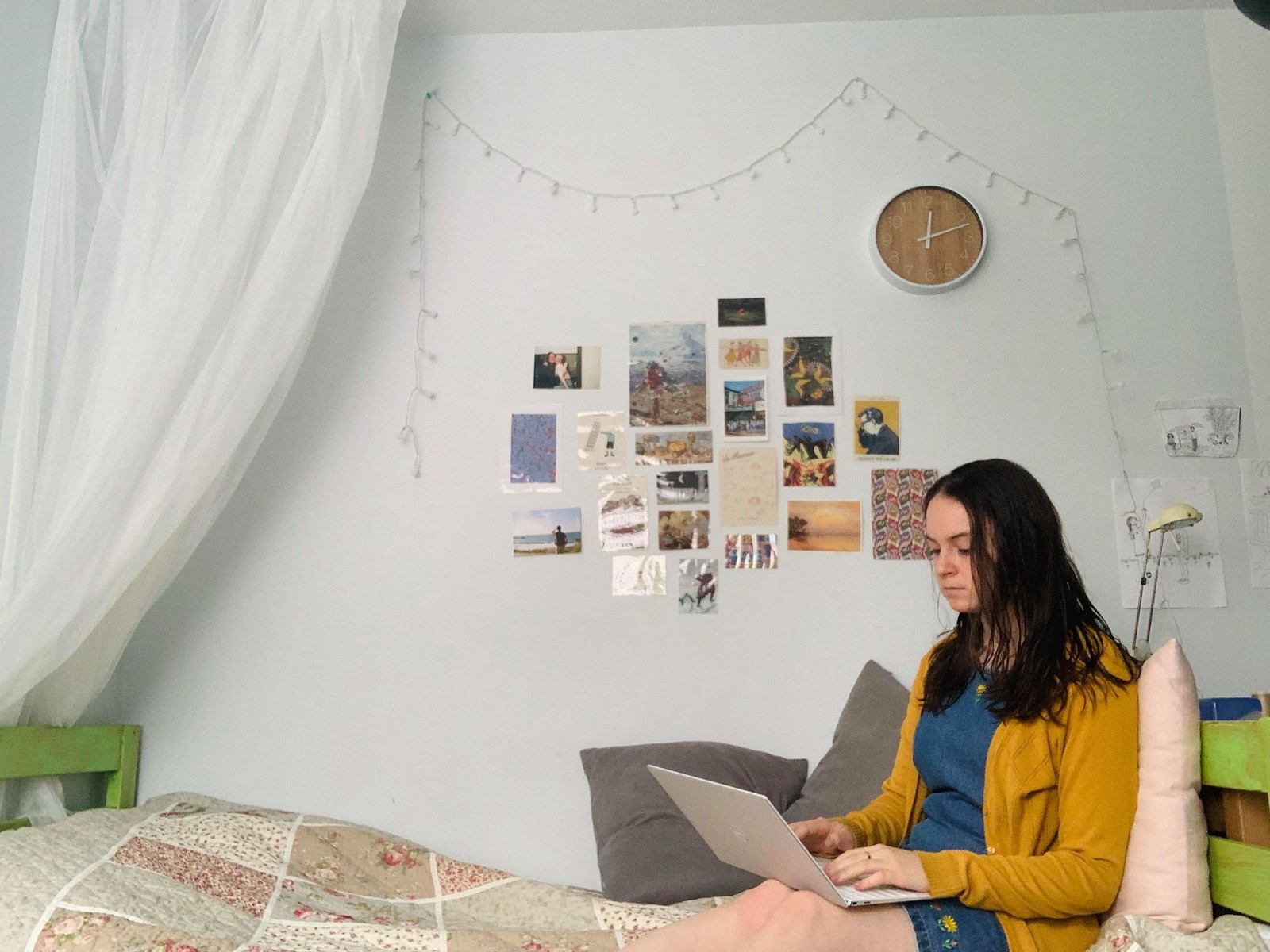 Danielle Slepyan using her laptop on her bed at home.