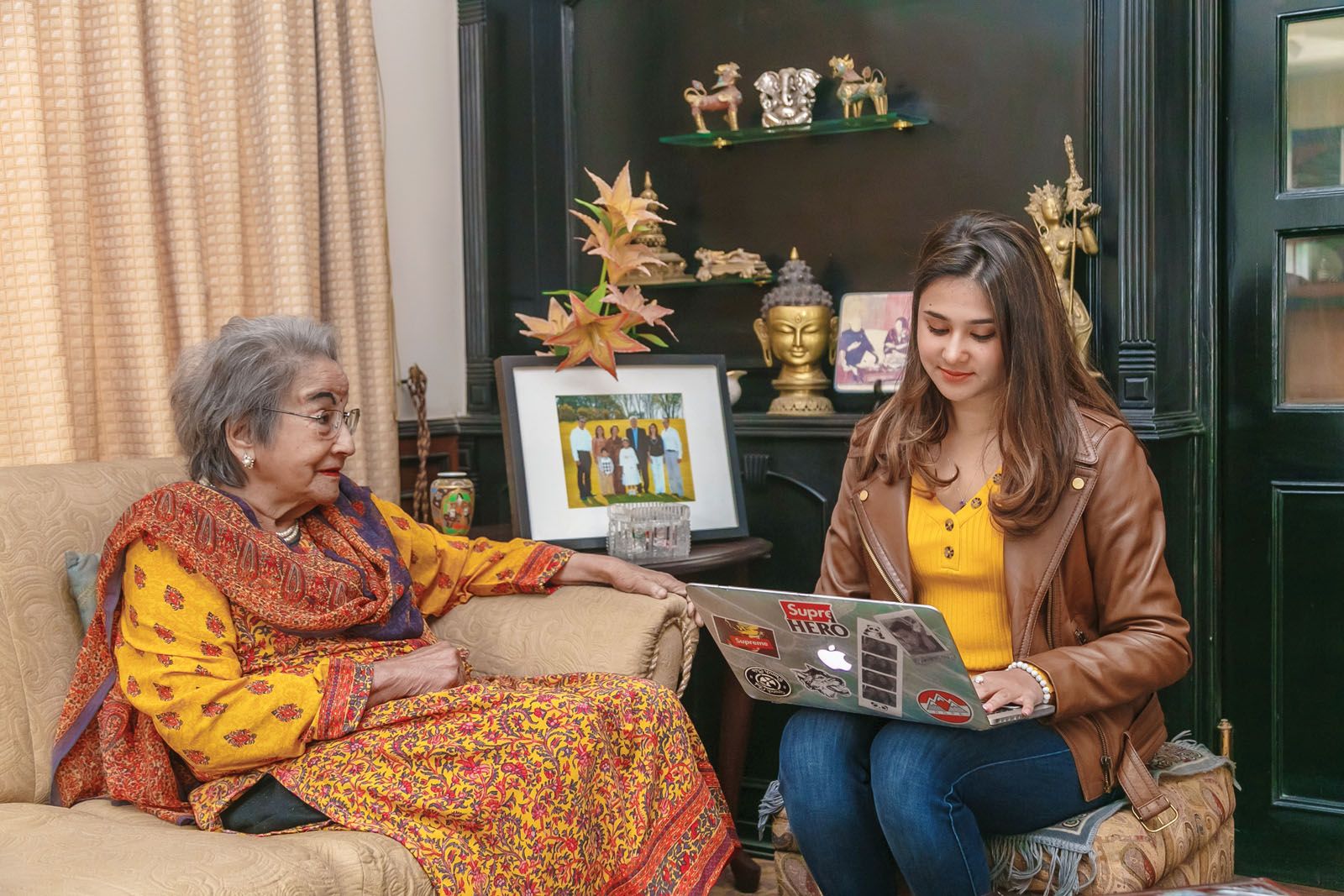 Elderly woman and young woman sitting together