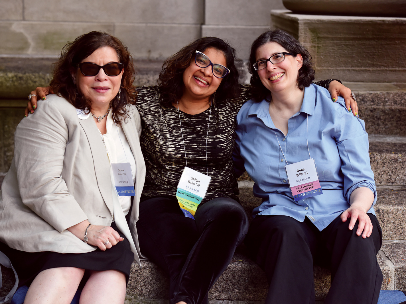 three women sitting and posing for a photo