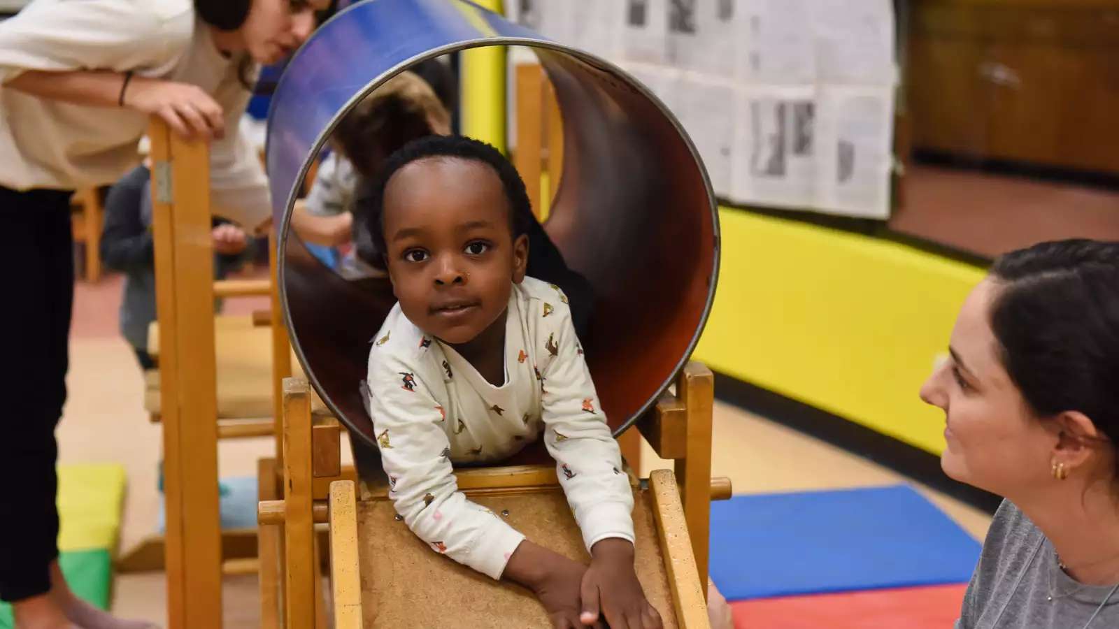 Toddler crawling through a tube