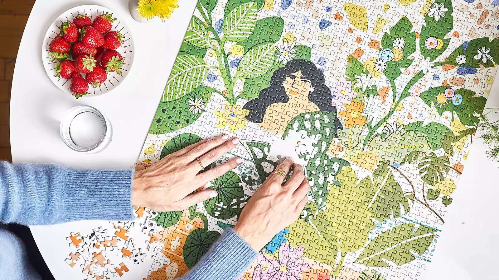 Hands assembling jigsaw puzzle