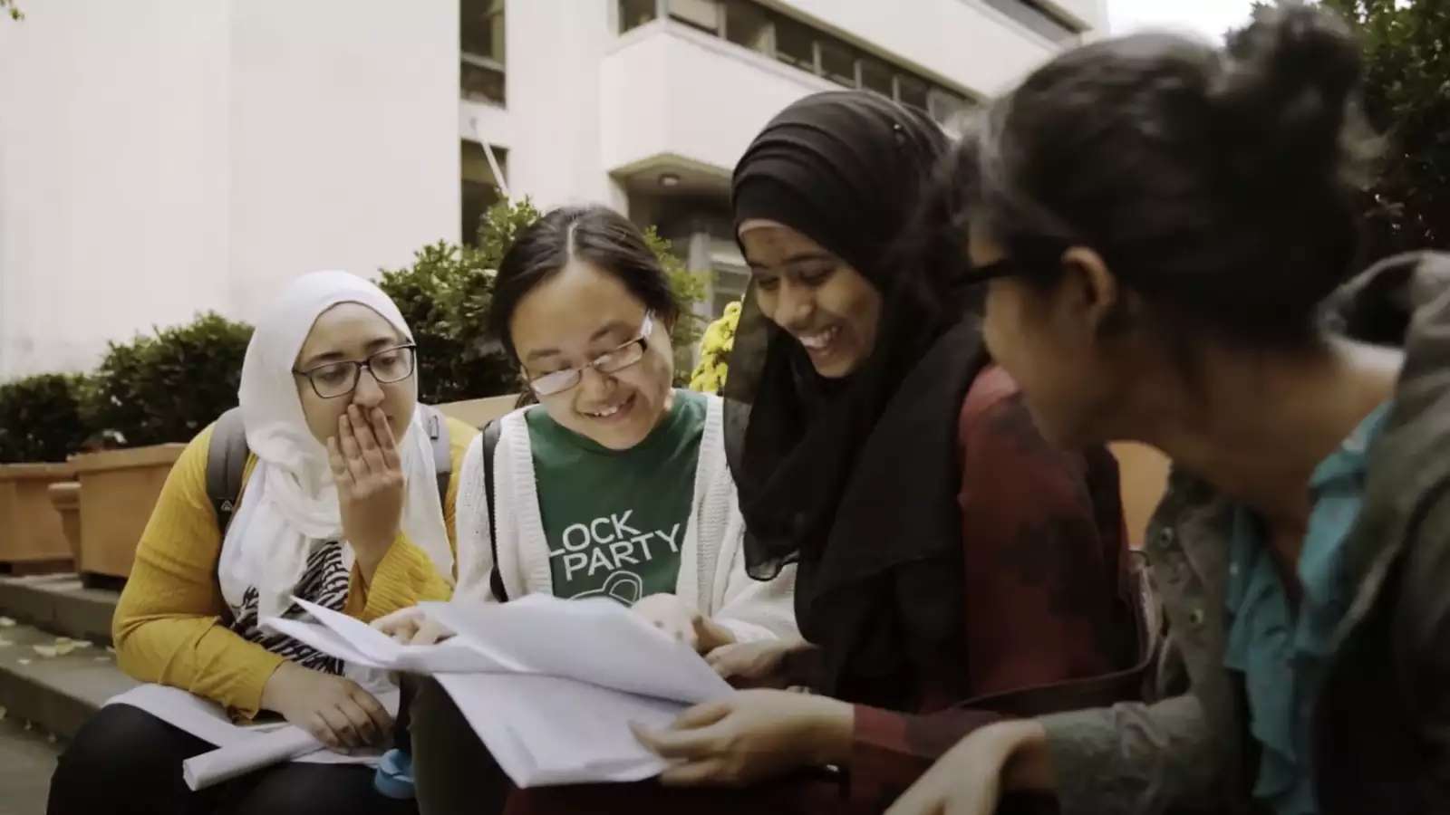 Four Barnard students gathered around papers reading