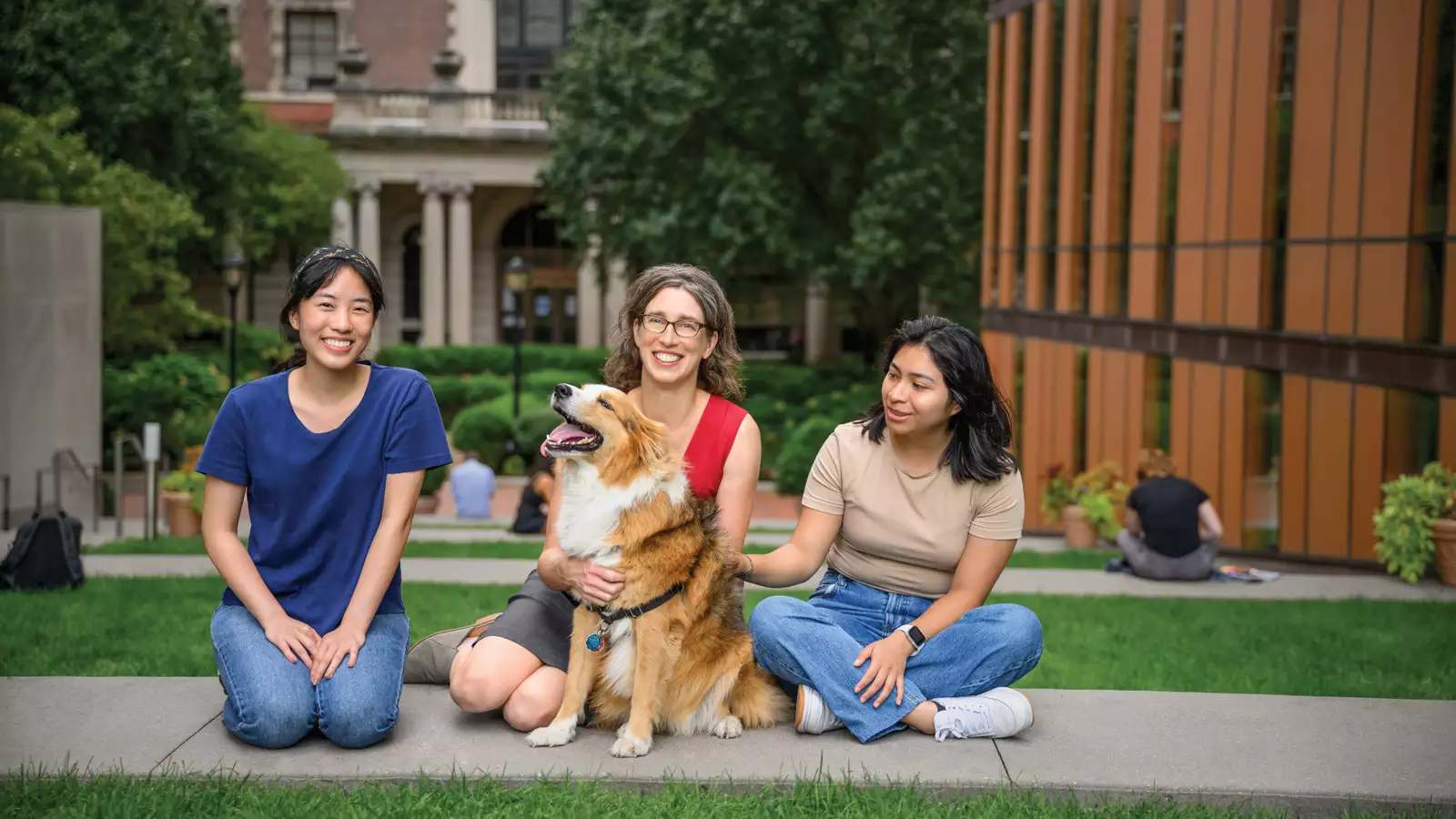 Alexandra Horowitz posing with students and a dog