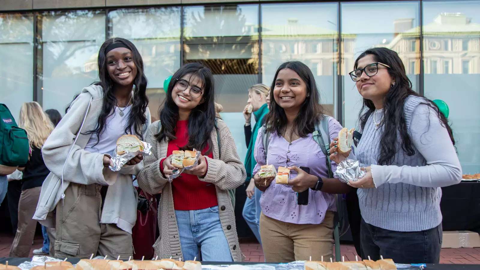 students at big sub posing with sandwich