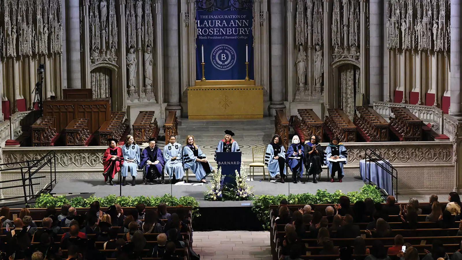 Wide photo of Laura Rosenbury speaking from the dais at Riverside Church at her inauguration as president of Barnard.