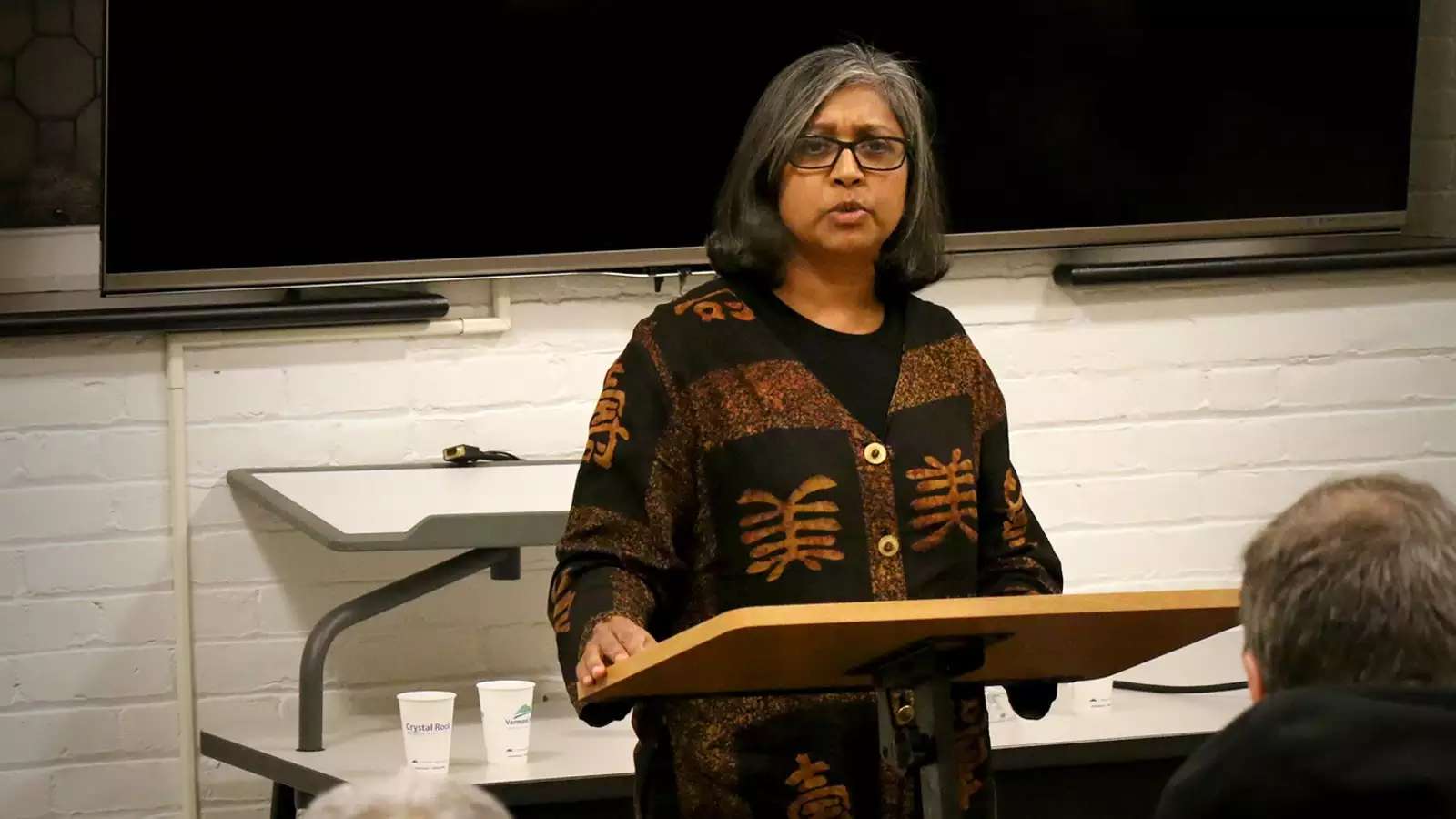 Premilla Nadasen standing at a podium