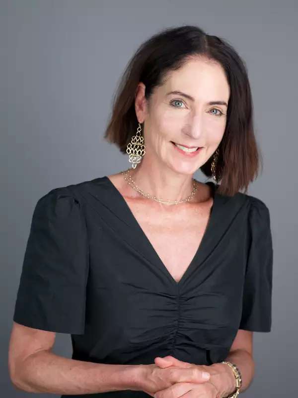 white woman with shoulder length hair looking into camera