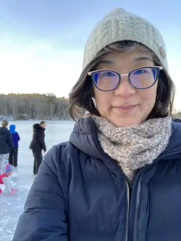 woman with glasses and white hat