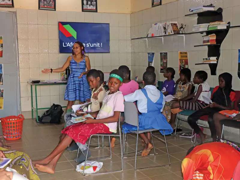 A classroom in West Africa with a teacher and a dozen children