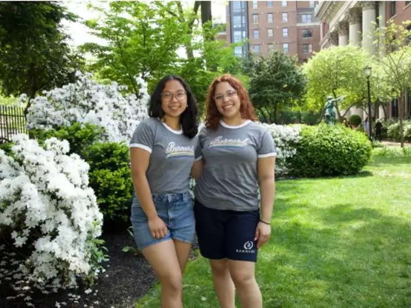 Barnard store student workers posing on Futter Field with spring flowers