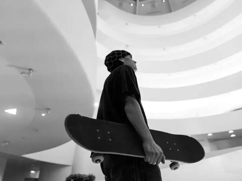 alexis sablone holding a skateboard in the Guggenheim