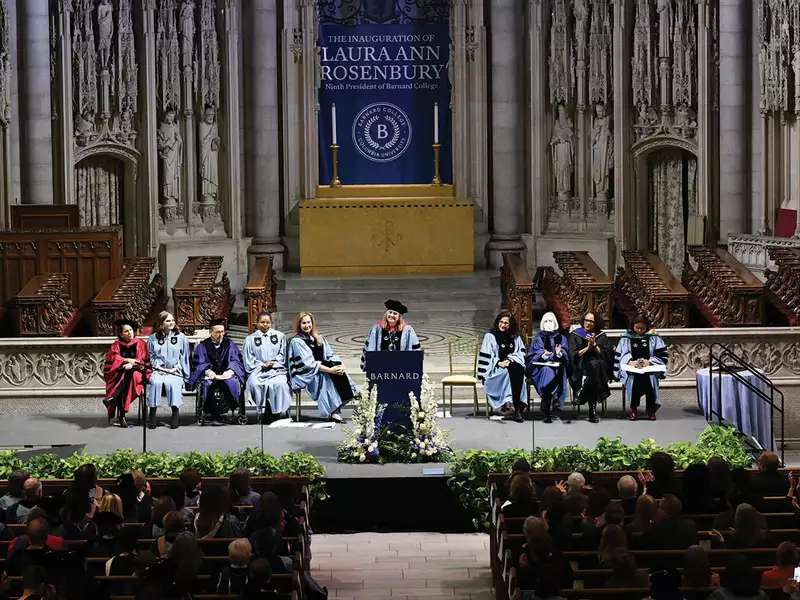 Wide photo of Laura Rosenbury speaking from the dais at Riverside Church at her inauguration as president of Barnard.