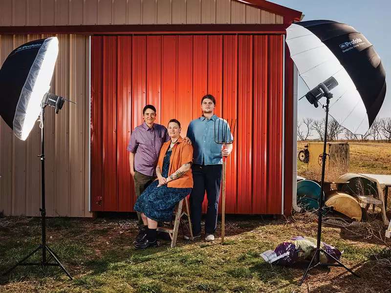 Midwest queer family poses before television lights. 