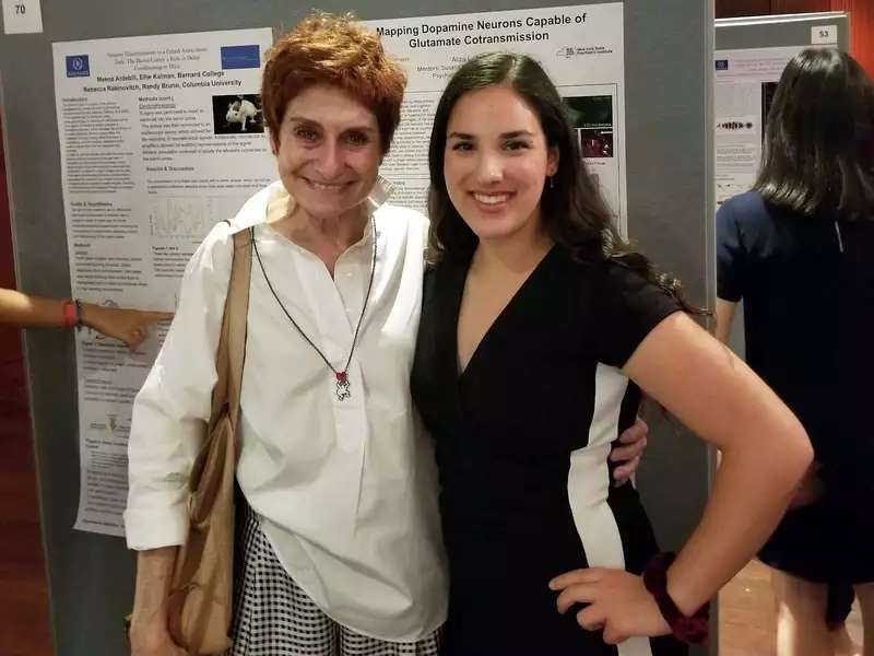 Two women side by side, smiling warmly