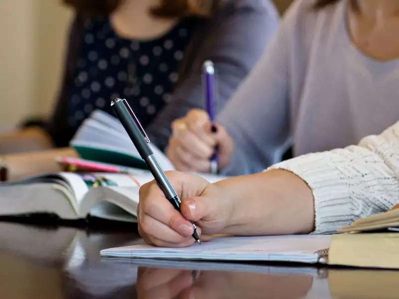 close up of a student writing in a notebook 